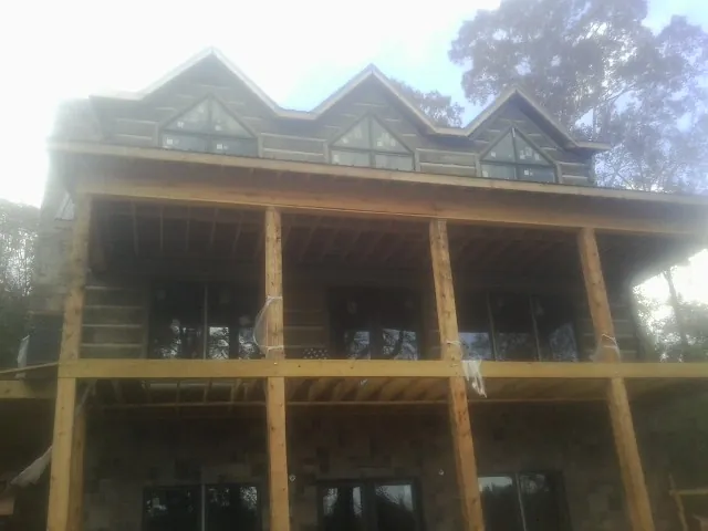 Dormers and porch framing on a large log home under construction in Rosedale